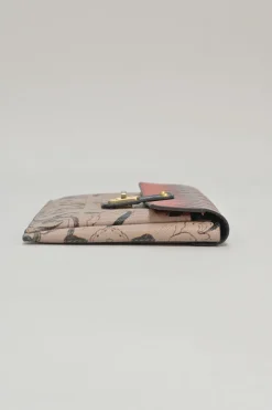 Orange grained printed leather turnlock flap envelope clutch featuring painterly floral motif