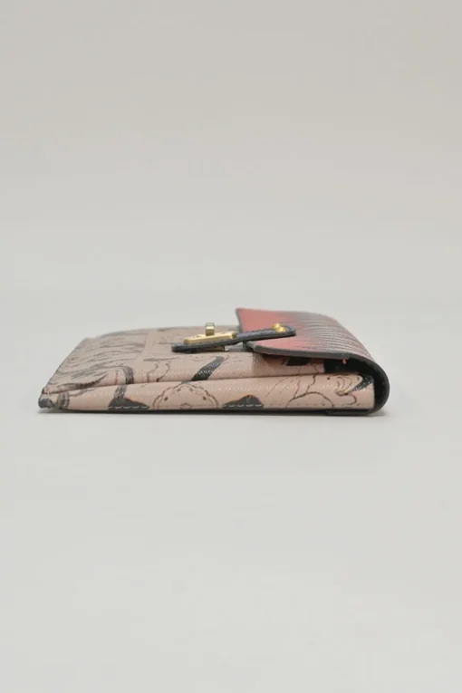 Orange grained printed leather turnlock flap envelope clutch featuring painterly floral motif