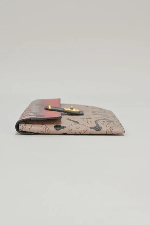 Orange grained printed leather turnlock flap envelope clutch featuring painterly floral motif