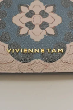 Orange grained printed leather turnlock flap envelope clutch featuring painterly floral motif
