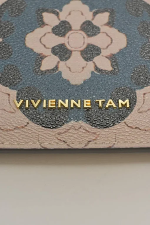 Orange grained printed leather turnlock flap envelope clutch featuring painterly floral motif