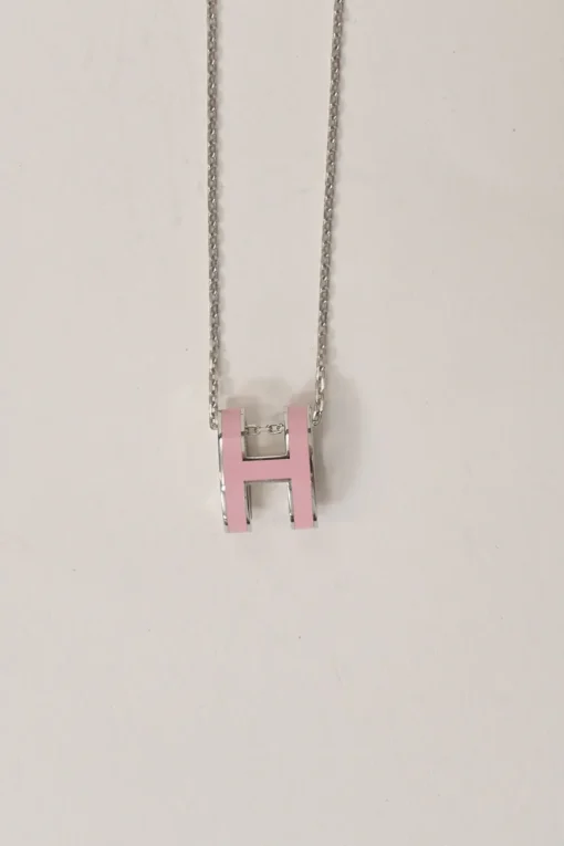 Palladium-plated silver-tone metal and pink enamel Pop H solitaire pendant necklace with lobster clasp closure