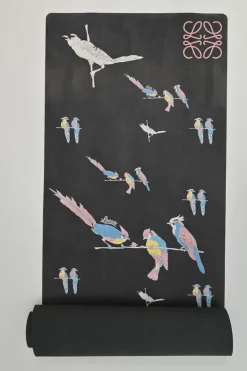 Paula's Ibiza 'The Combo' black micro fiber-covered rubber yoga mat featuring novelty parrot motif