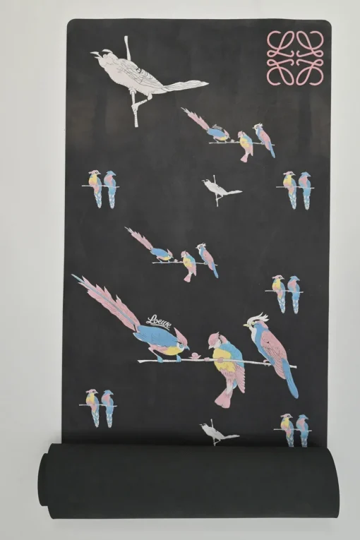 Paula's Ibiza 'The Combo' black micro fiber-covered rubber yoga mat featuring novelty parrot motif