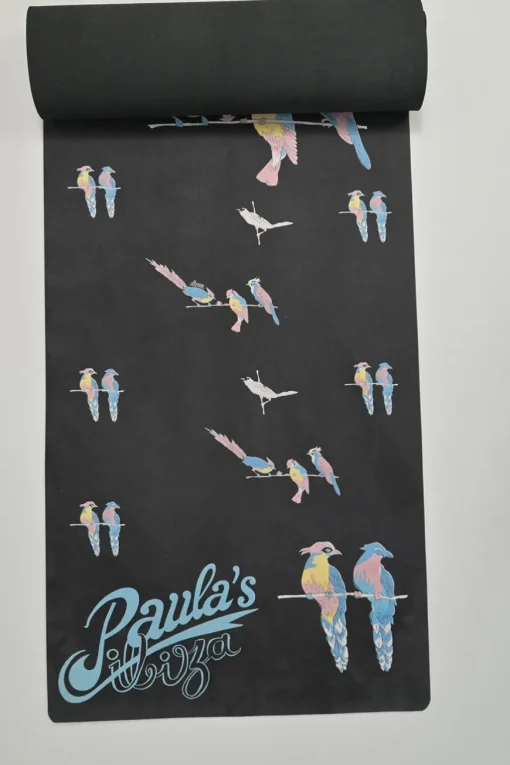 Paula's Ibiza 'The Combo' black micro fiber-covered rubber yoga mat featuring novelty parrot motif