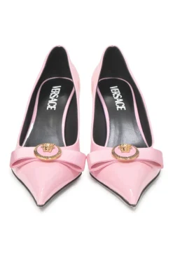 Pink patent leather sharp-point toe Gianni Bow 110 stiletto pumps featuring signature Nastro Gianni bow with enameled Medusa hardware