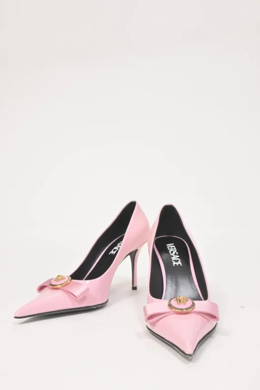Pink patent leather sharp-point toe Gianni Bow 110 stiletto pumps featuring signature Nastro Gianni bow with enameled Medusa hardware