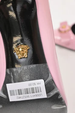 Pink patent leather sharp-point toe Gianni Bow 110 stiletto pumps featuring signature Nastro Gianni bow with enameled Medusa hardware