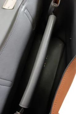 Prada single top handle bag in camel with contrasting grey flap.
