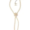 Resin faux pearl and gold-finish metal floral lariat necklace with lobster clasp closure