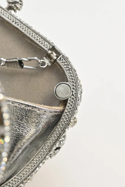 Silver crystal-embellished chain skull clutch with kiss lock fastening