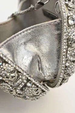 Silver crystal-embellished chain skull clutch with kiss lock fastening
