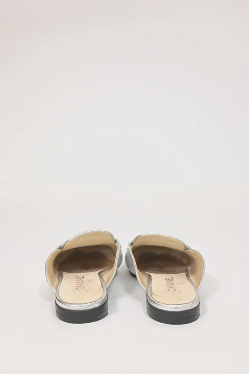 Silver foiled leather round-toe slip-on mules with camellia medallion appliqué