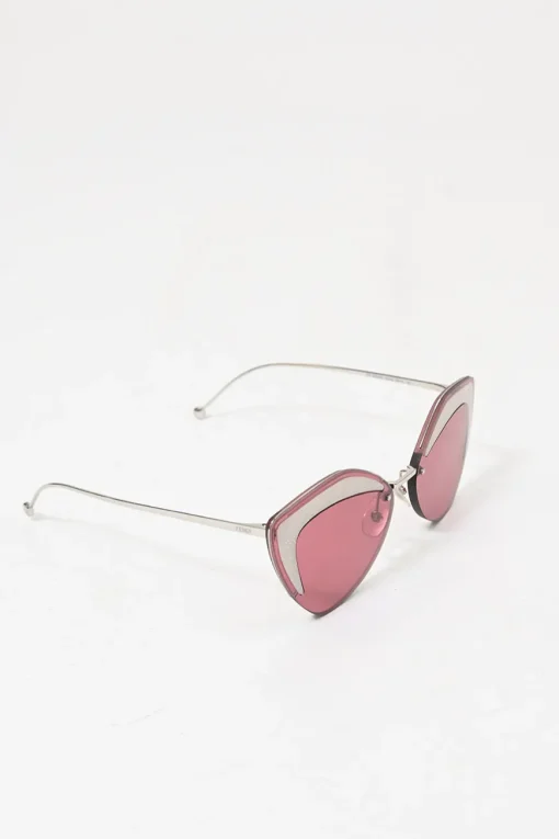 Silver-tone metal and pink tinted polycarbonate rimless cat-eye sunglasses with glitter accents