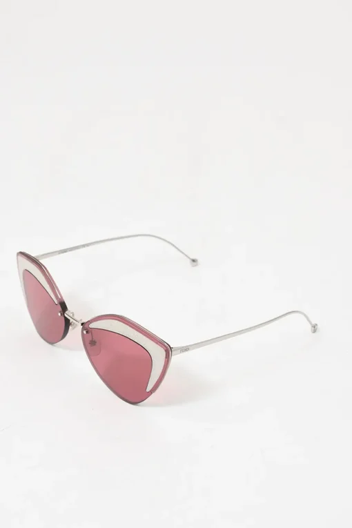 Silver-tone metal and pink tinted polycarbonate rimless cat-eye sunglasses with glitter accents