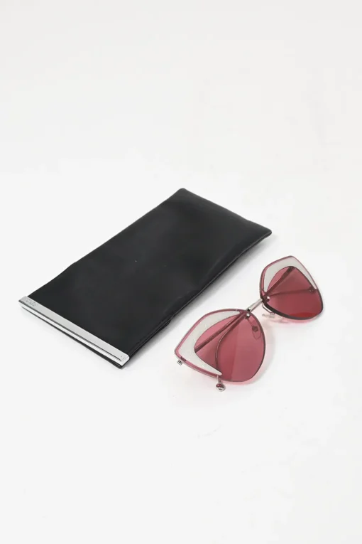 Silver-tone metal and pink tinted polycarbonate rimless cat-eye sunglasses with glitter accents