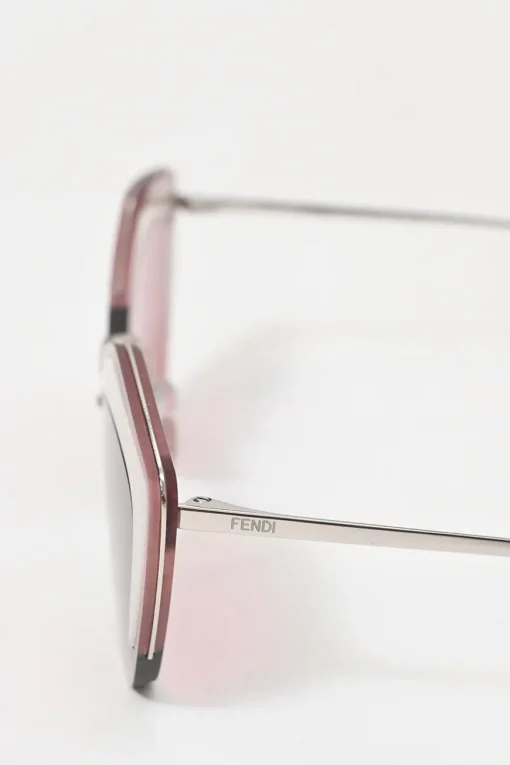 Silver-tone metal and pink tinted polycarbonate rimless cat-eye sunglasses with glitter accents