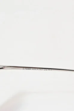 Silver-tone metal and pink tinted polycarbonate rimless cat-eye sunglasses with glitter accents