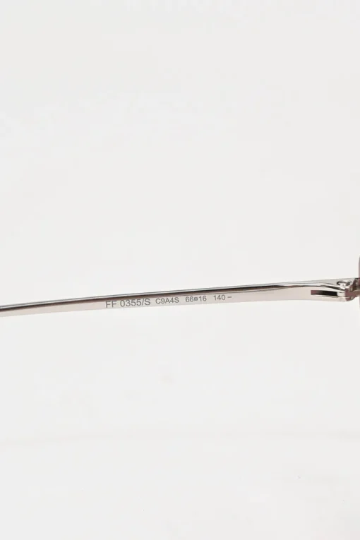 Silver-tone metal and pink tinted polycarbonate rimless cat-eye sunglasses with glitter accents