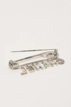 Strass-embellished silver-finish metal logo charm safety pin brooch