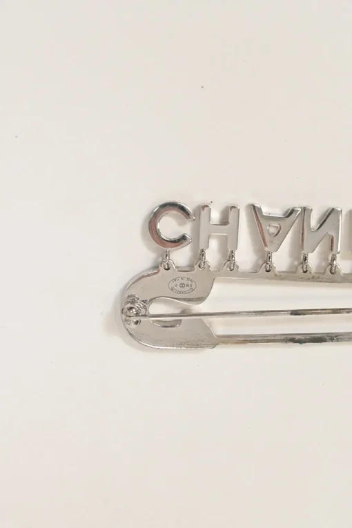 Strass-embellished silver-finish metal logo charm safety pin brooch