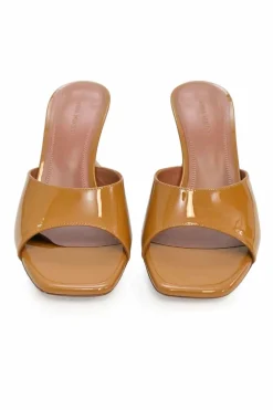 Tan patent leather and leather Lupita slide sandals with sculpted comma heels