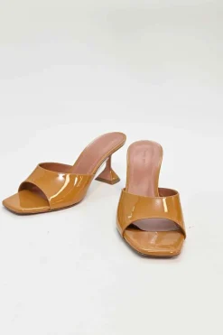 Tan patent leather and leather Lupita slide sandals with sculpted comma heels