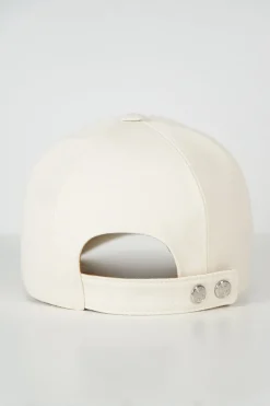 'Tess Cap' in off white cotton canvas with interior "Quadrige" badge and adjustment tab with two polished palladium plated Clou de Selle details