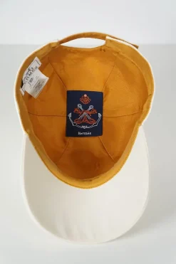 'Tess Cap' in off white cotton canvas with interior "Quadrige" badge and adjustment tab with two polished palladium plated Clou de Selle details