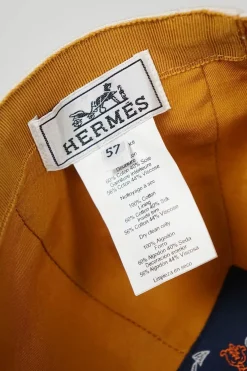 'Tess Cap' in off white cotton canvas with interior "Quadrige" badge and adjustment tab with two polished palladium plated Clou de Selle details