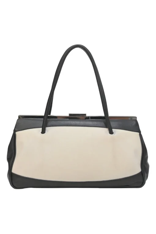 Two-tone canvas and leather frame shoulder bag with metallic push-lock closure