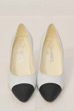 Two-tone leather and grosgrain pointed-toe cone heel pumps featuring metallic Coco Mark plaque appliqué