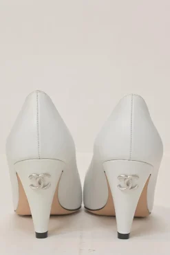 Two-tone leather and grosgrain pointed-toe cone heel pumps featuring metallic Coco Mark plaque appliqué