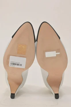 Two-tone leather and grosgrain pointed-toe cone heel pumps featuring metallic Coco Mark plaque appliqué