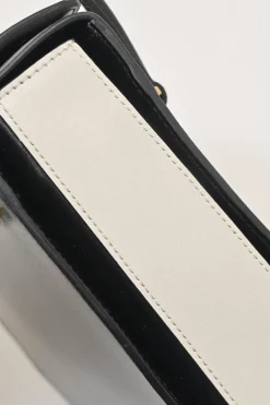 Two-tone leather top handle bag with turnlock fastening