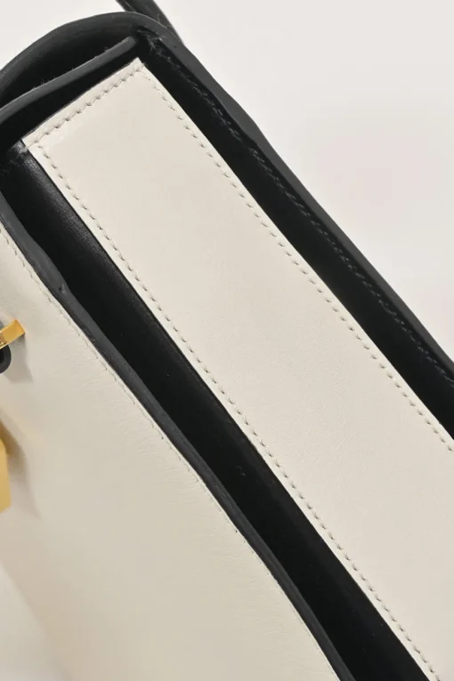Two-tone leather top handle bag with turnlock fastening