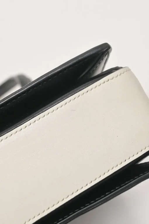 Two-tone leather top handle bag with turnlock fastening