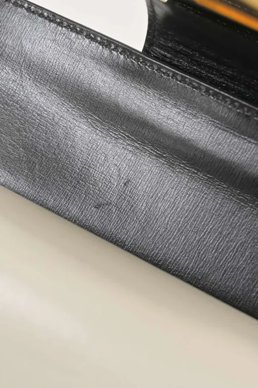 Two-tone leather top handle bag with turnlock fastening