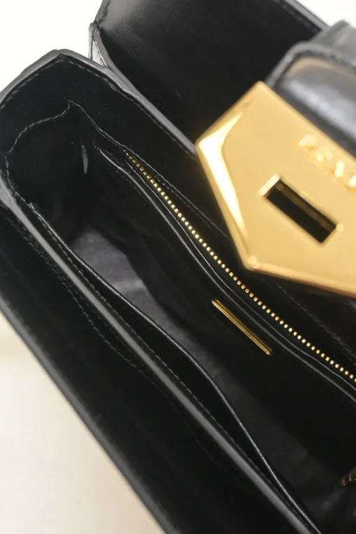 Two-tone leather top handle bag with turnlock fastening