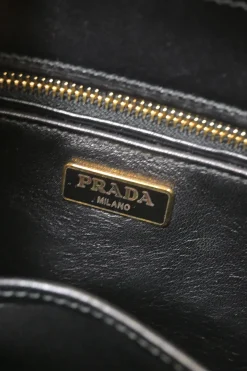 Two-tone leather top handle bag with turnlock fastening