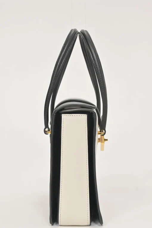 Two-tone leather top handle bag with turnlock fastening