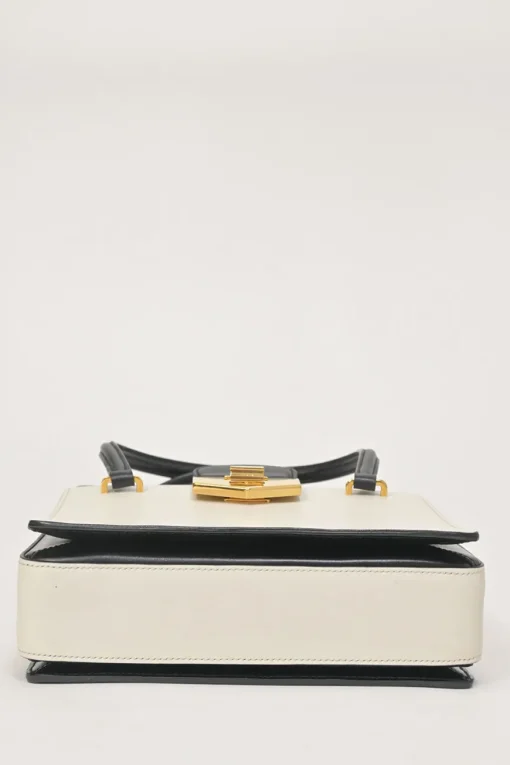 Two-tone leather top handle bag with turnlock fastening