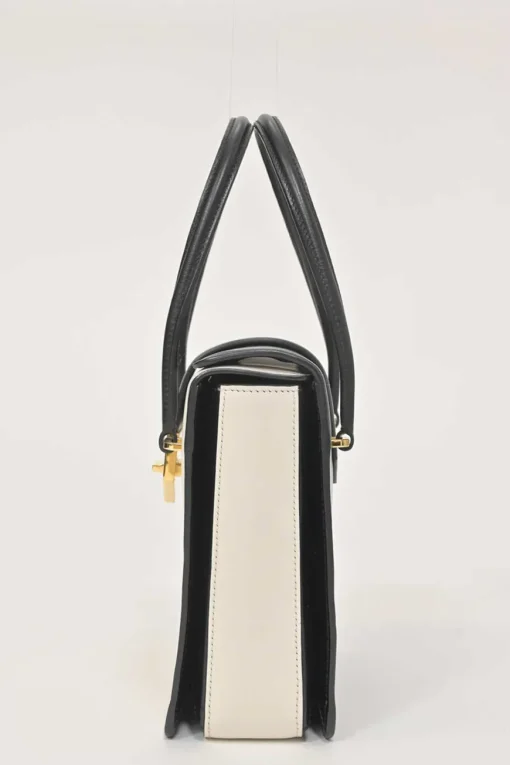 Two-tone leather top handle bag with turnlock fastening