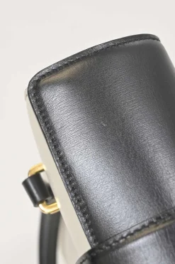 Two-tone leather top handle bag with turnlock fastening