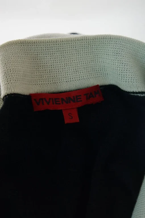Washed black cotton polo top with contrasting collar, cuffs, and hem