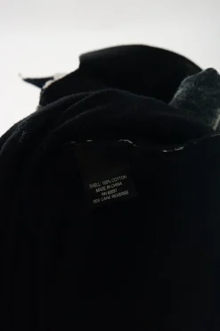 Washed black cotton polo top with contrasting collar, cuffs, and hem