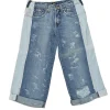 Washed indigo cotton denim low-rise distressed capri pants with rolled-up cuffs