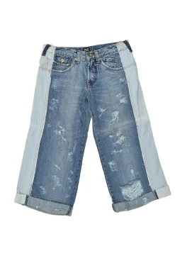 Washed indigo cotton denim low-rise distressed capri pants with rolled-up cuffs