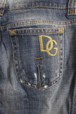 Washed indigo cotton denim low-rise bootcut jeans with whiskering details at hip level
