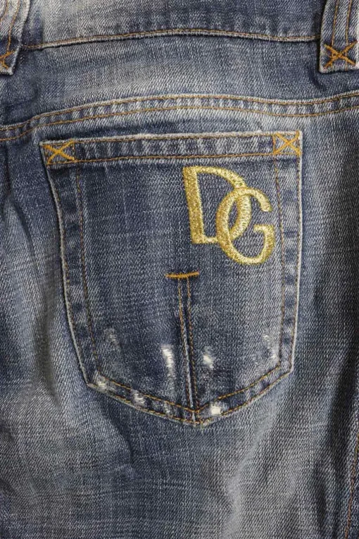 Washed indigo cotton denim low-rise bootcut jeans with whiskering details at hip level